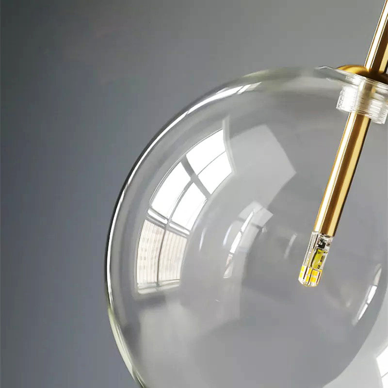 Pendant light casting warm glow through glass sphere