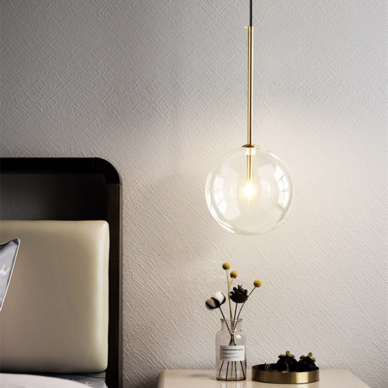 Gold pendant light illuminated in kitchen setting
