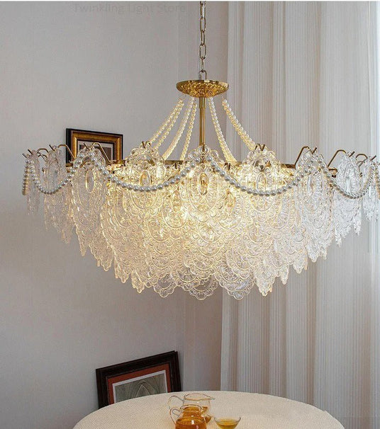 The lit fitting above a round white table with a picture frame resting on it