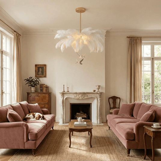 The fitting above two pink sofas facing a marble fireplace and a coffee table