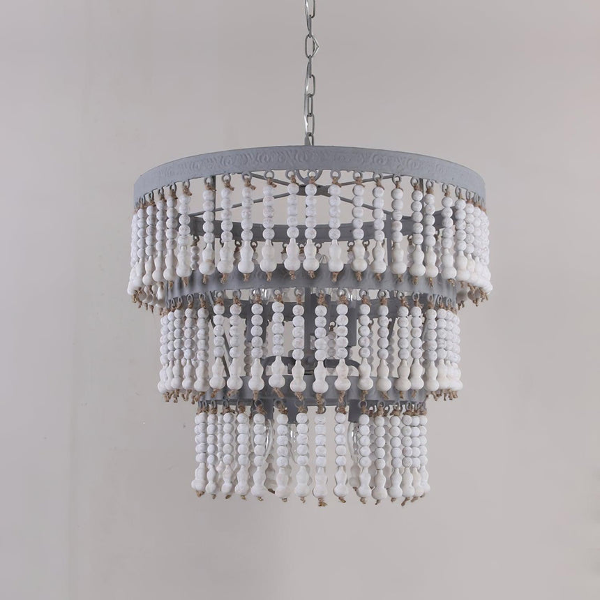 The fitting unlit against a gray wall, showing the drum rim and bead tiers