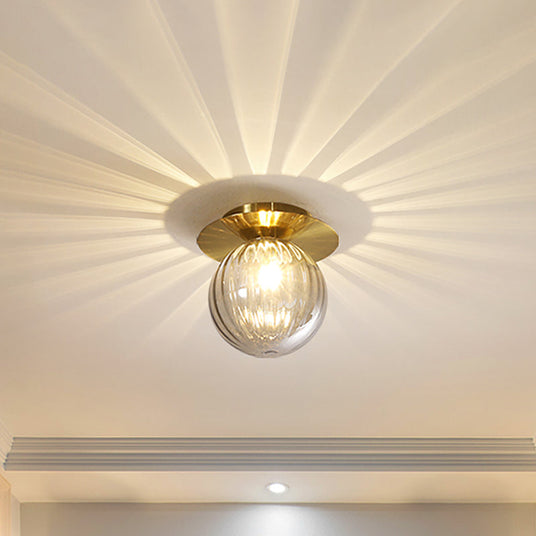 Gold glass LED ceiling light with sleek modern silhouette