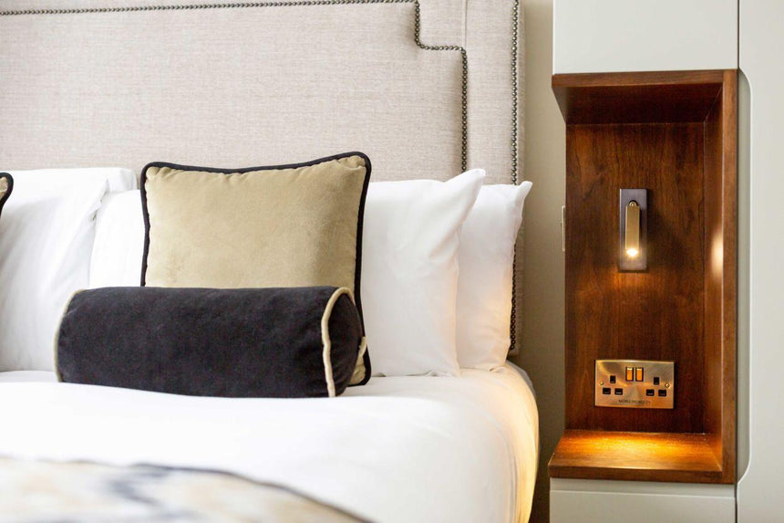 Unobtrusive wall sconce for compact bedrooms