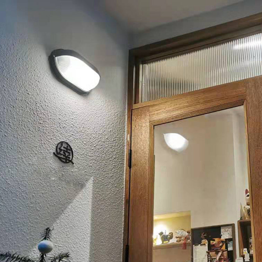 Outdoor wall lamp illuminated at dusk