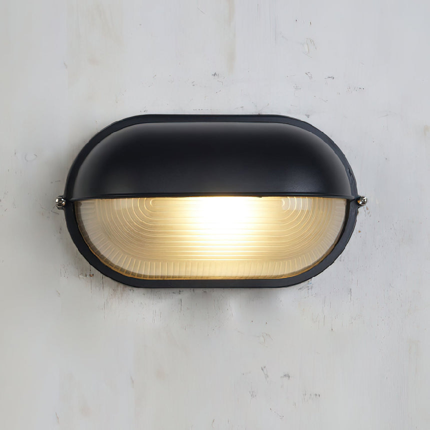 Wall lamp casting glow on exterior brick wall
