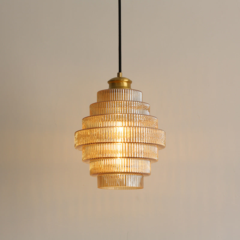 Brass and glass pendant light with sleek modern silhouette