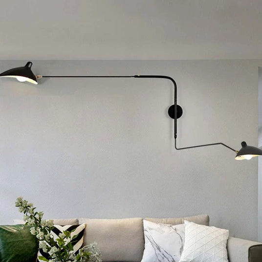 Metal wall sconce mounted above a reading chair