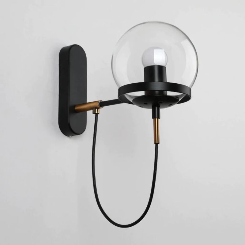 Metal ring detail on glass wall sconce