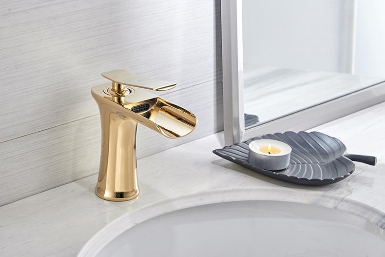 Brass waterfall bathroom faucet installed in a bathroom setting