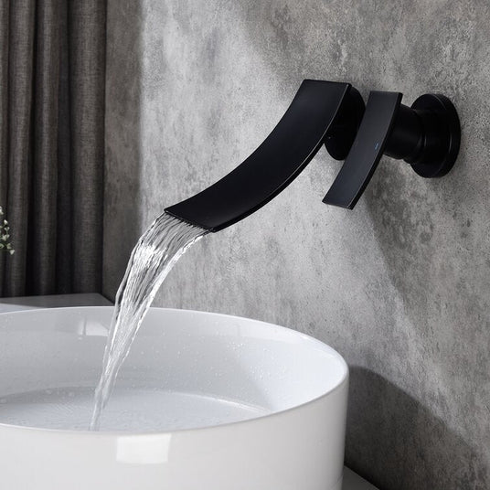 Wall mounted waterfall faucet installed in a bathroom setting