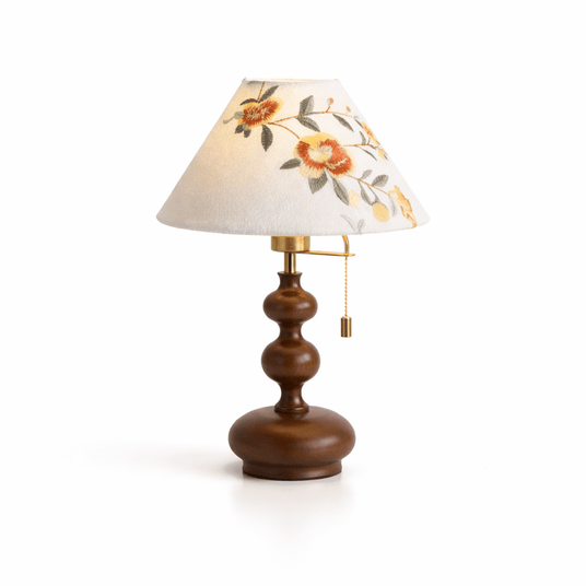 Floral shade lamp seen from an angle showing the stacked turnings
