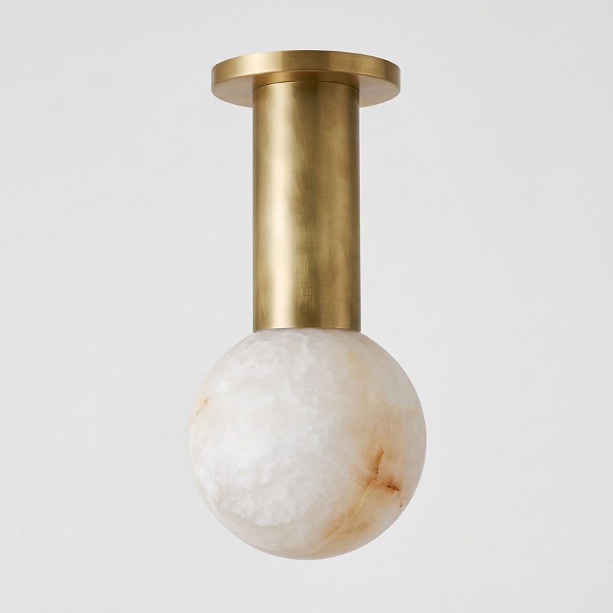 Brass column alabaster sphere ceiling light shown close up against a plain background