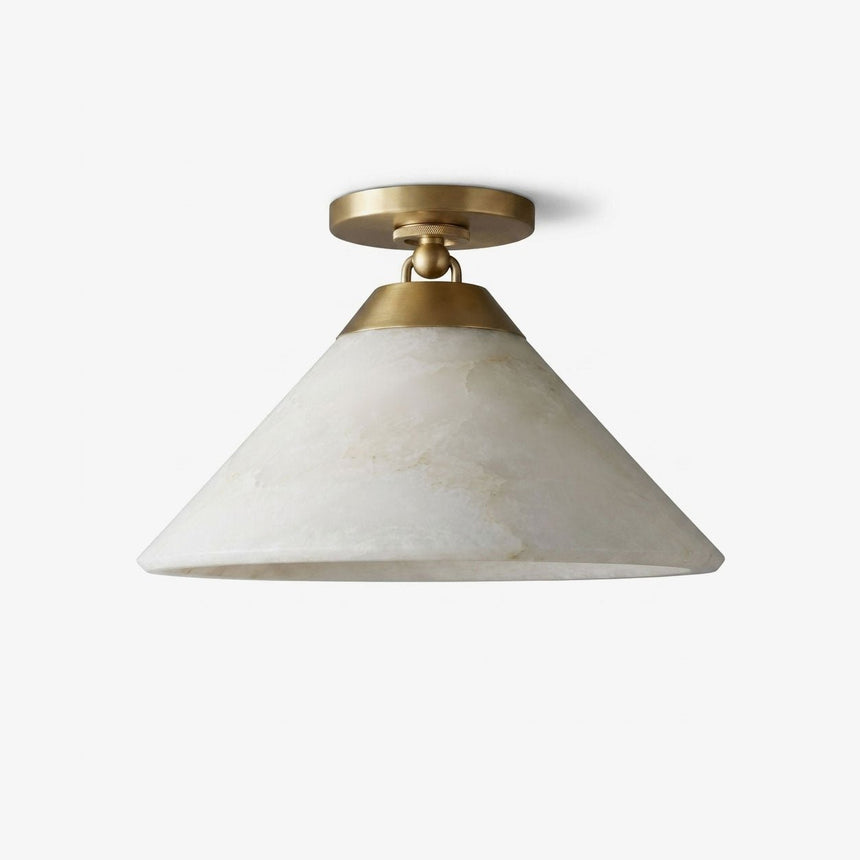 Alabaster flush mount ceiling light with a wide tapered stone shade on a brass fitting