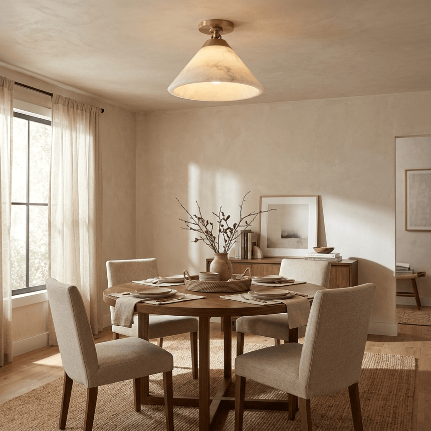 Alabaster cone ceiling light in a dining room with sheer curtains and pale chairs