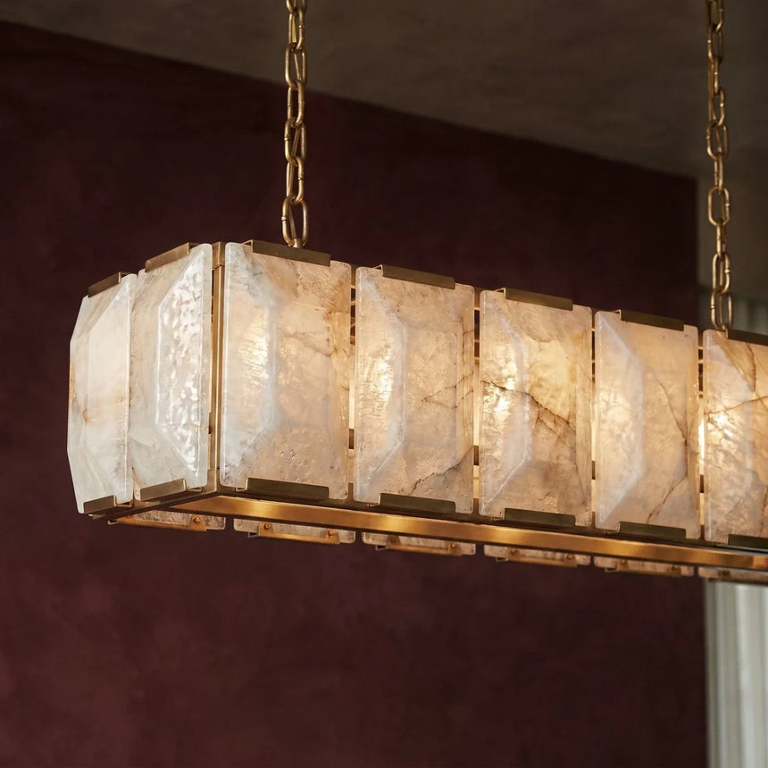 The brass frame and lit stone panels seen close from below