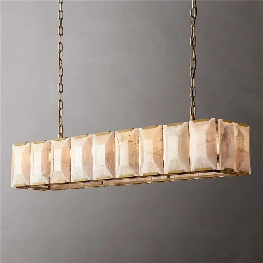 A brass framed cage of lit stone panels seen from one corner
