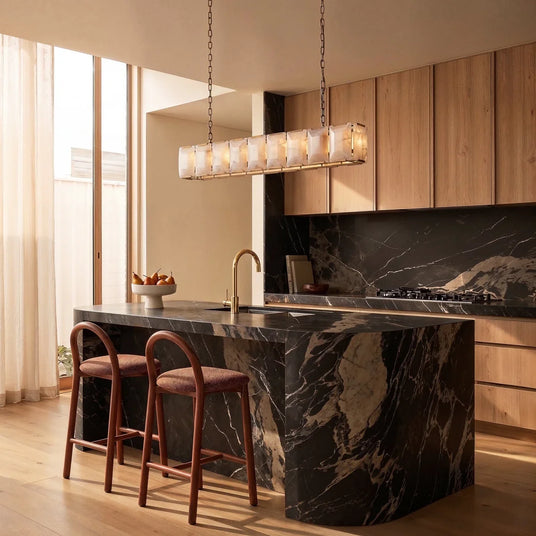 A lit stone cage above a kitchen island with two stools