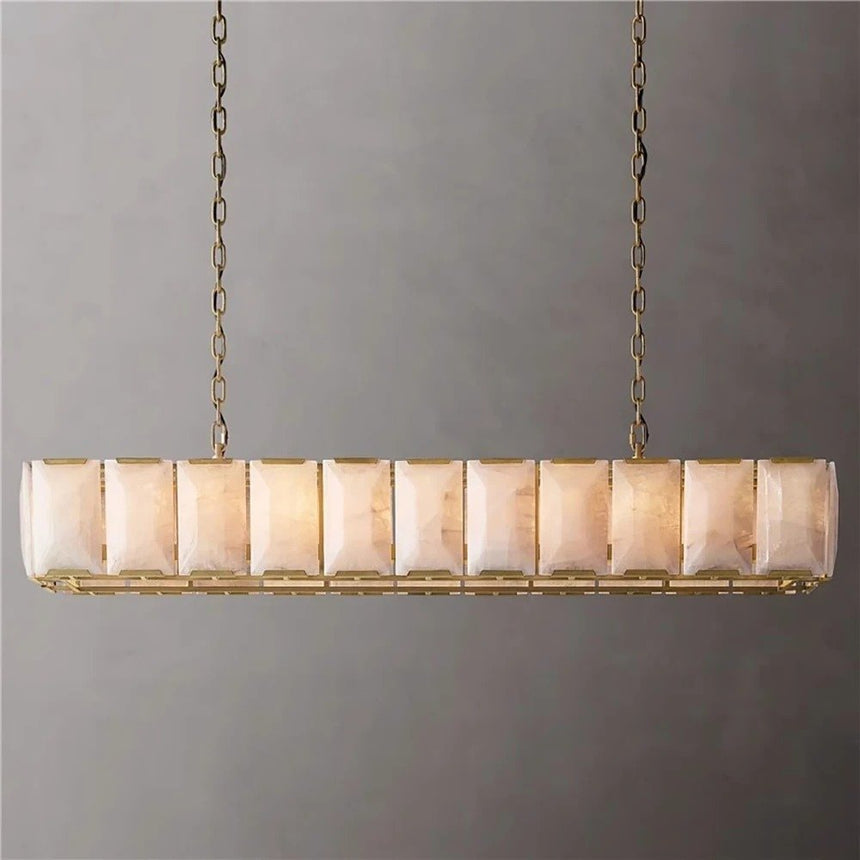 A long cage of faceted stone panels in a brass frame on chains