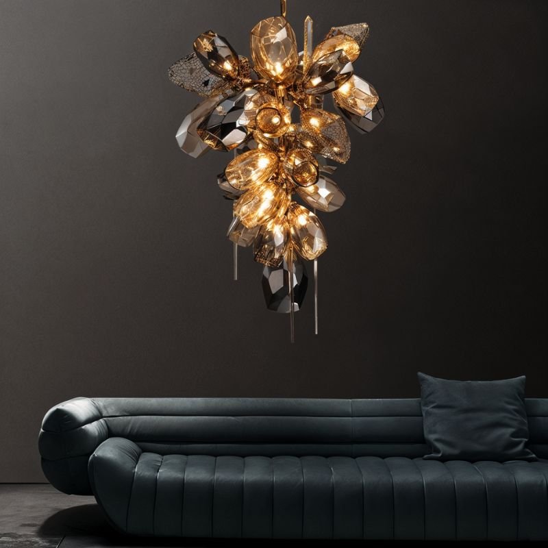 The tall cascade lit in a dark room above a deep blue sofa with cushions