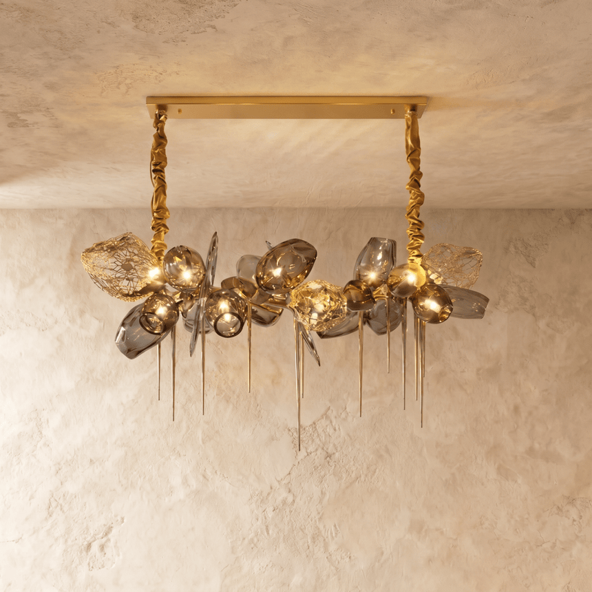 The linear version, amber glass petals massed along a gold bar with brass spikes