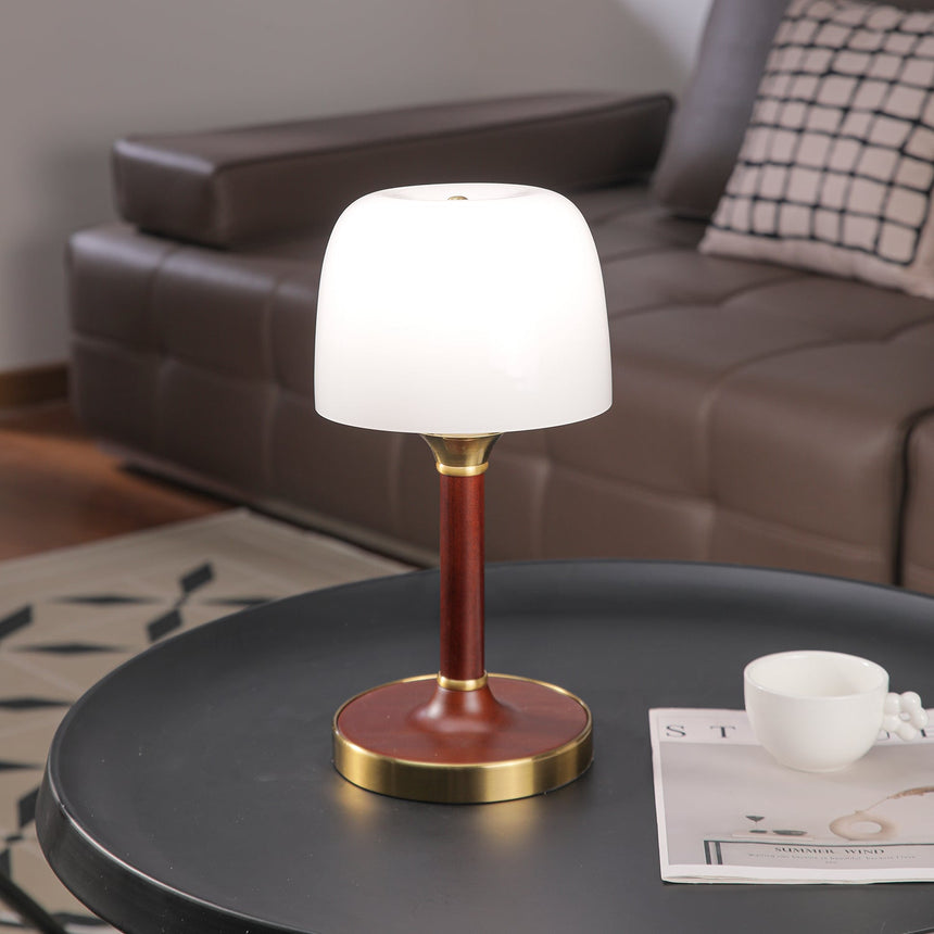 The white glass version lit brightly beside a leather sofa