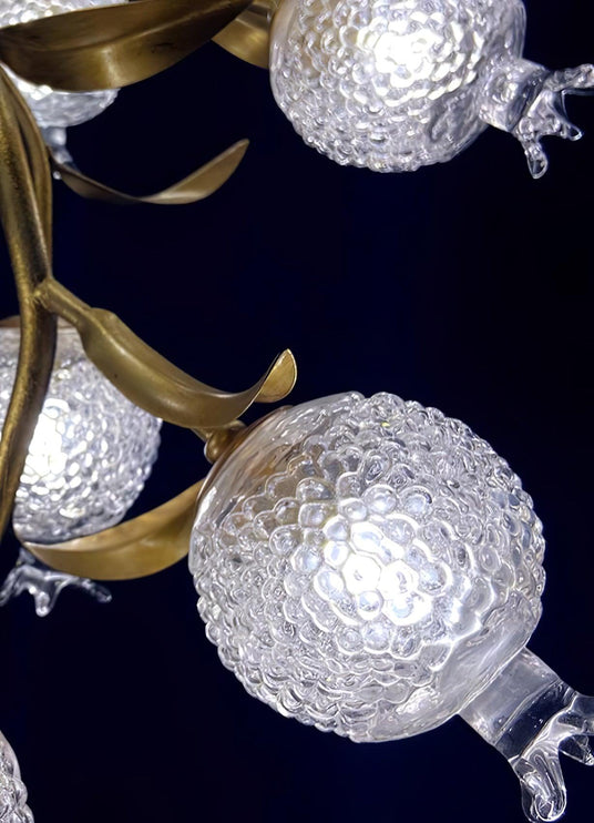 Close view of the brass leaves and two frosted glass globes