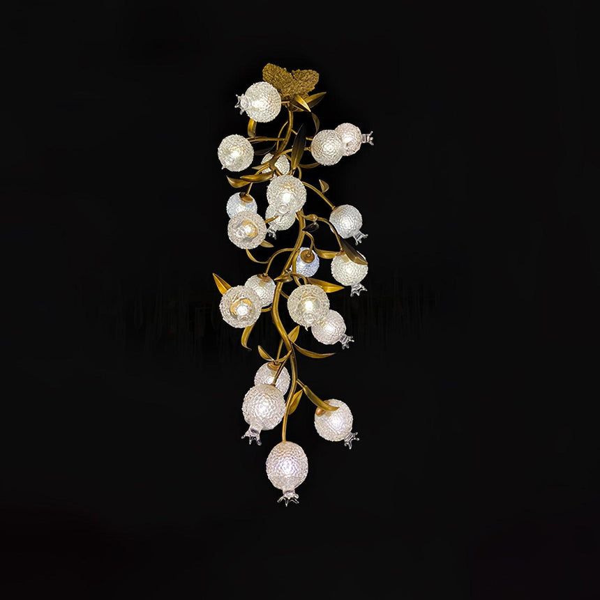 Brass branch chandelier seen full length against a black background