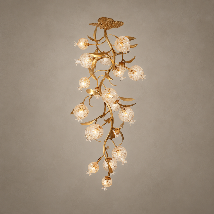 Brass branch chandelier seen full length against a beige background