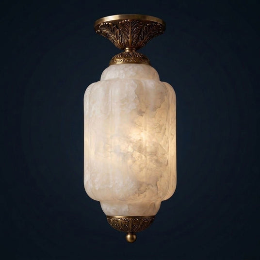 Antique brass stone ceiling light lit against a dark blue background
