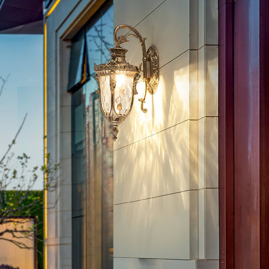 The lantern lit beside a classical doorway with a pediment above it
