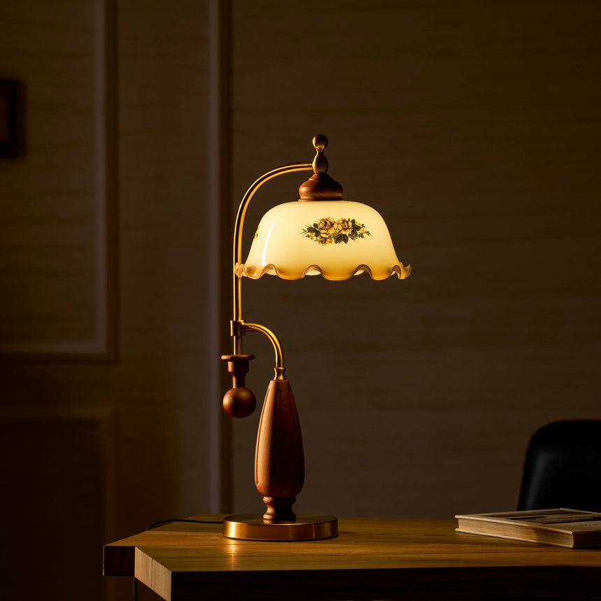 Antique brass table lamp lit on a desk in a dark room