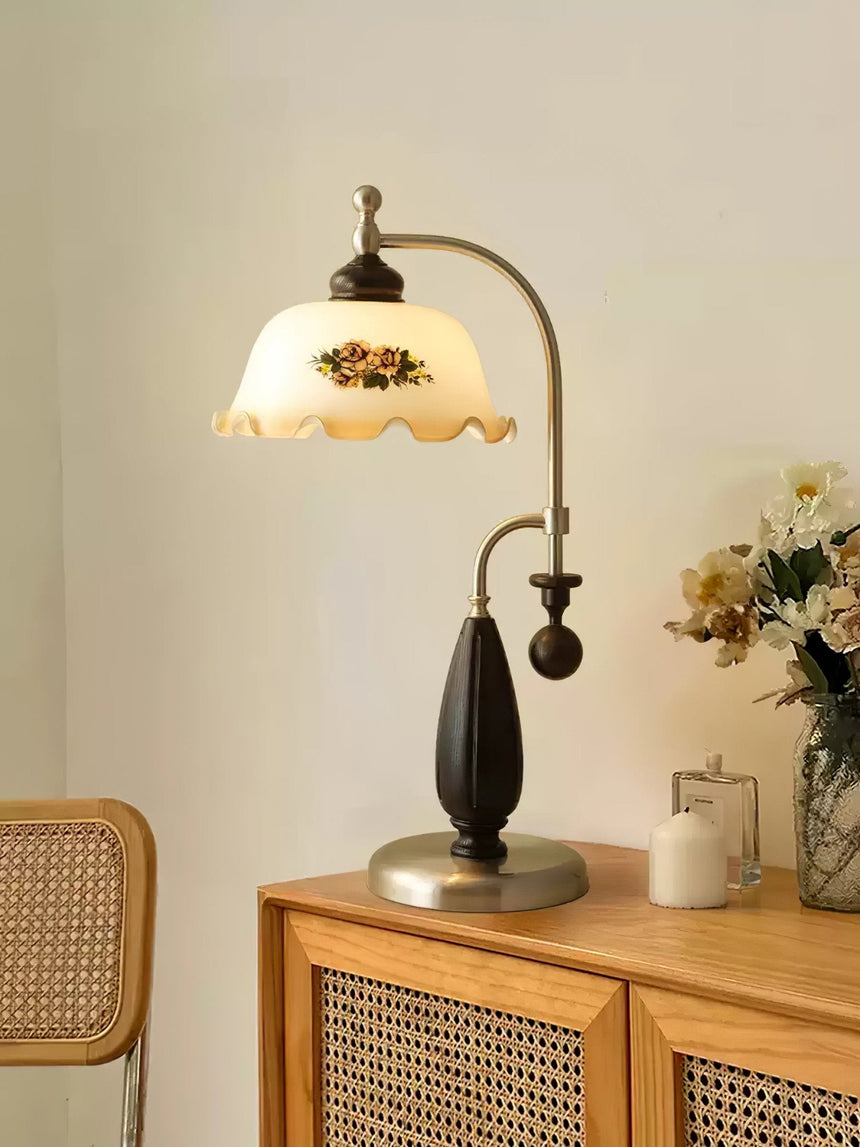 Antique brass table lamp lit on a cane fronted sideboard