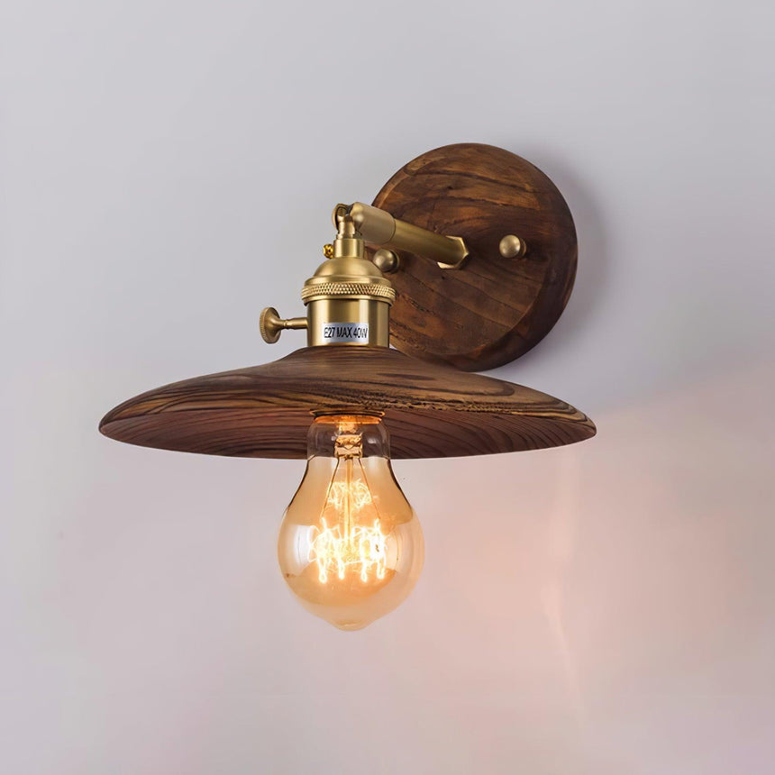 Close view of the lit fitting, the Edison bulb under the walnut shade