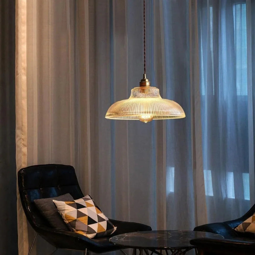 Amber shade over a lounge corner with a patterned armchair and long curtains