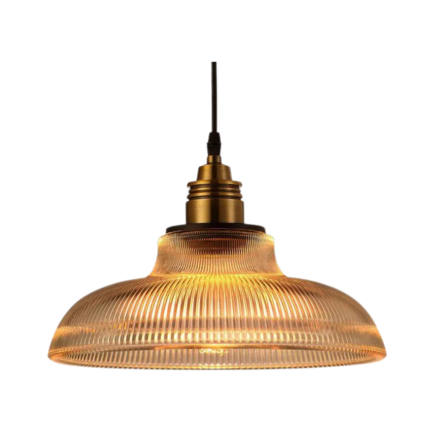 Amber prismatic glass shade with a brass top on a plain gray background