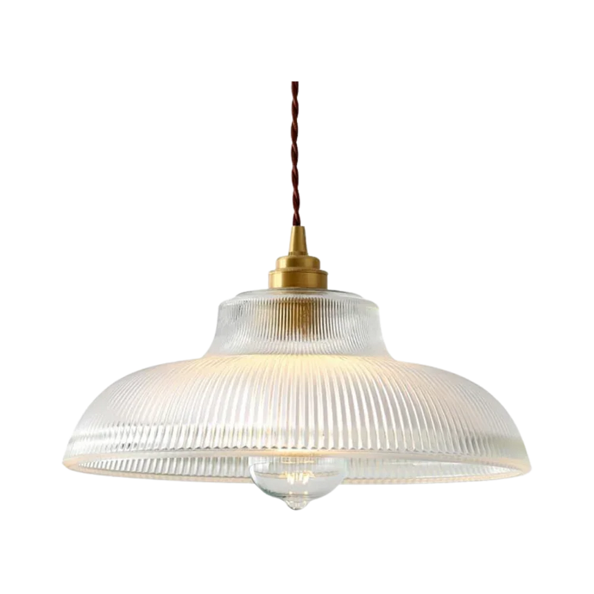 Clear prismatic glass shade with a brass top on a plain gray background