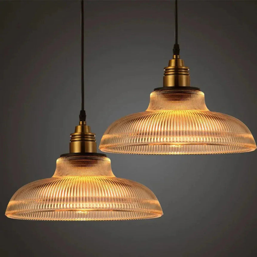 Two amber prismatic shades lit side by side on a plain dark background