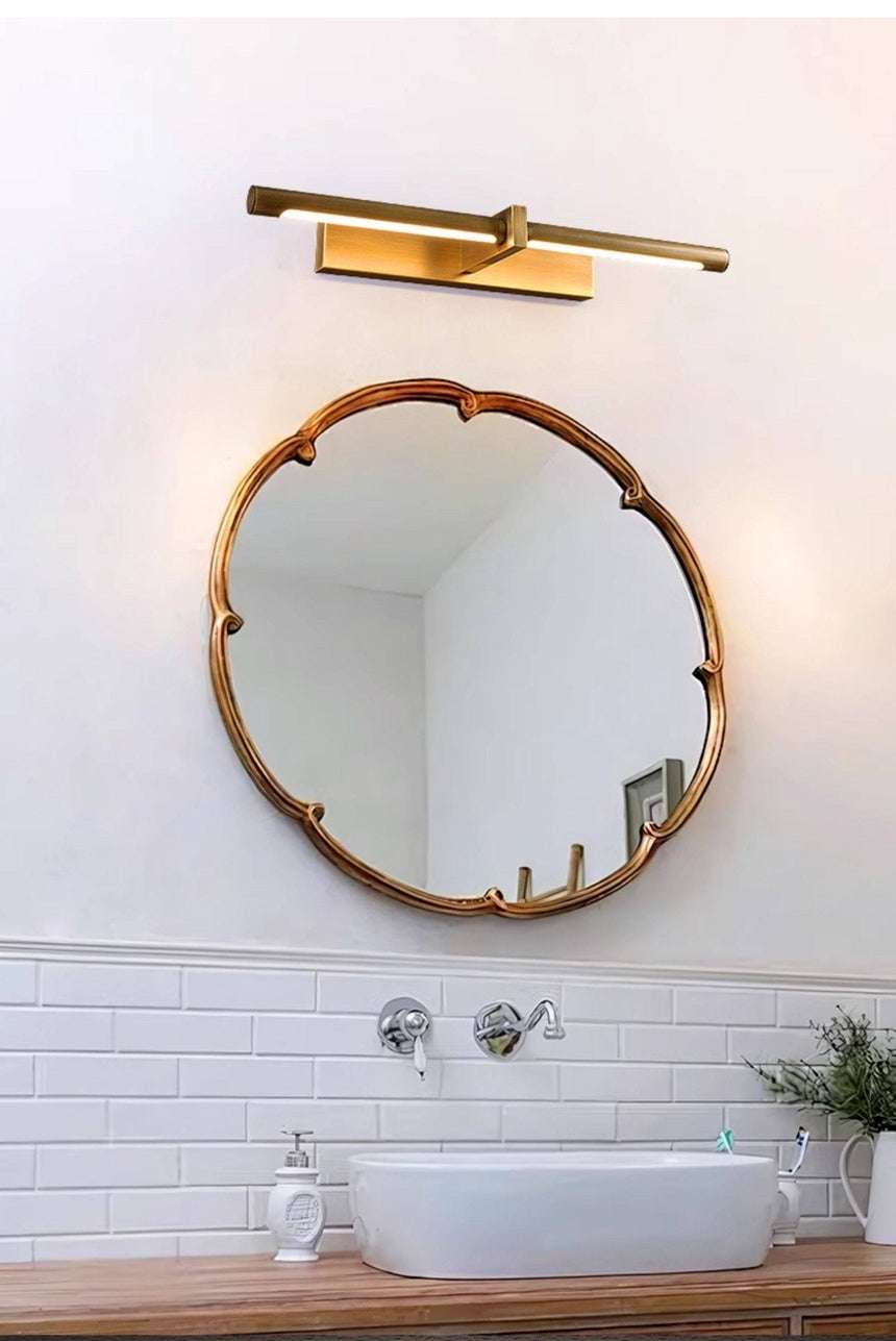 Brass twin bar above a scalloped mirror over a basin and a tiled wall