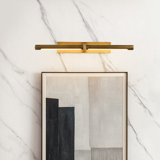 Brass twin bar lit above a framed artwork on a marble clad wall