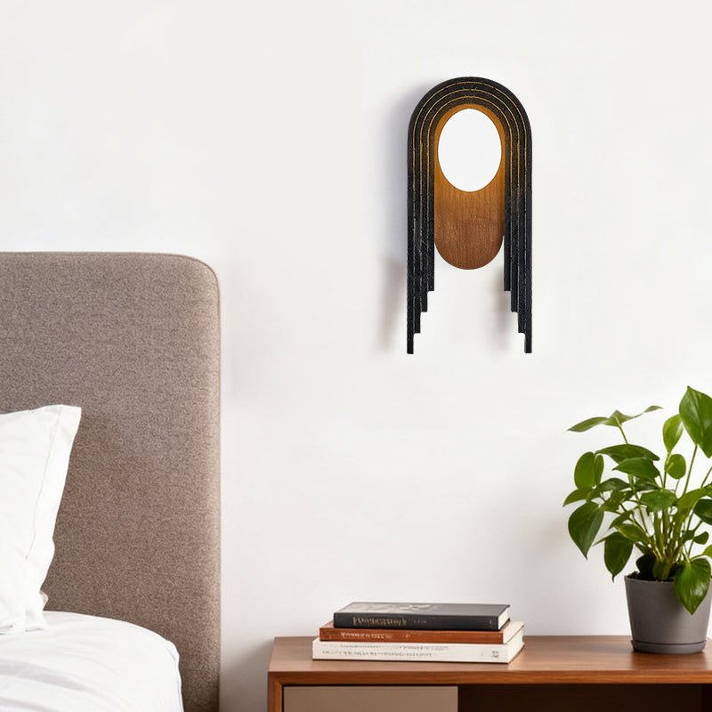The arch lamp above a wood nightstand with books and a plant beside a bed
