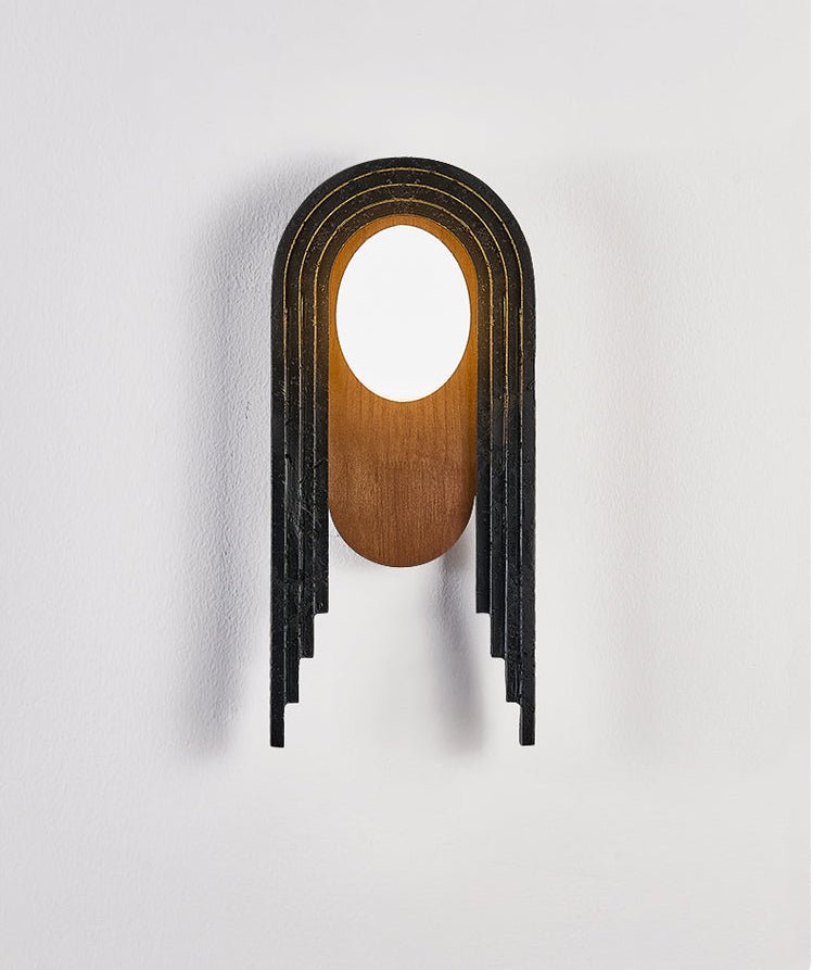 The lamp seen from the front, the stepped black bands around the walnut oval