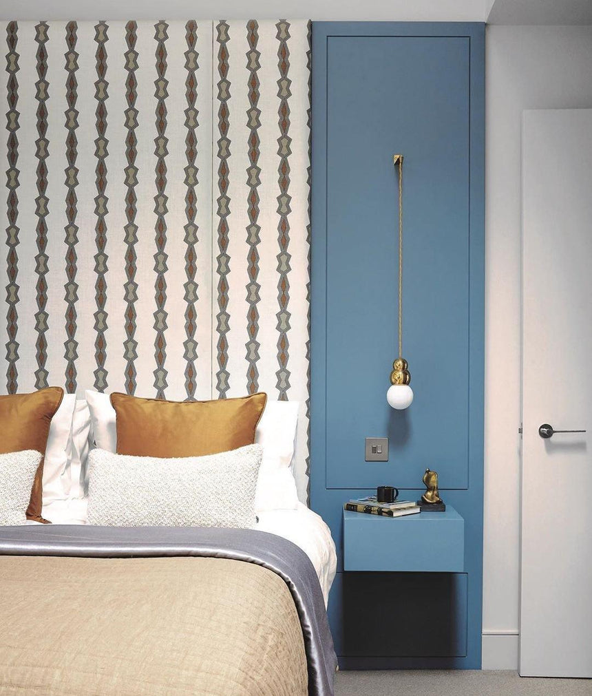 The ball light hanging in a blue niche beside a bed