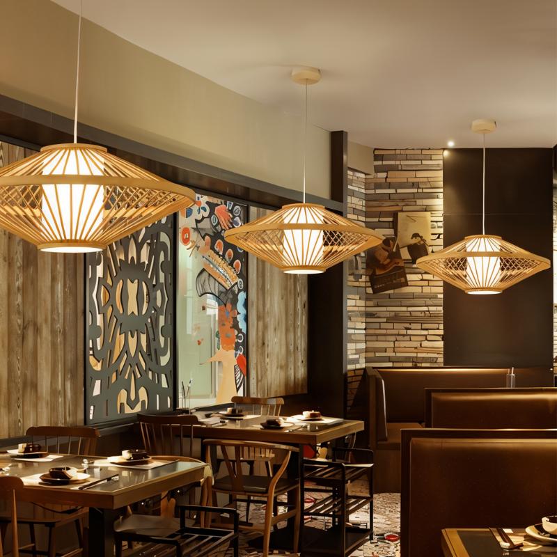 Four of the bamboo shades hung above a set restaurant table and chairs by a painted wall