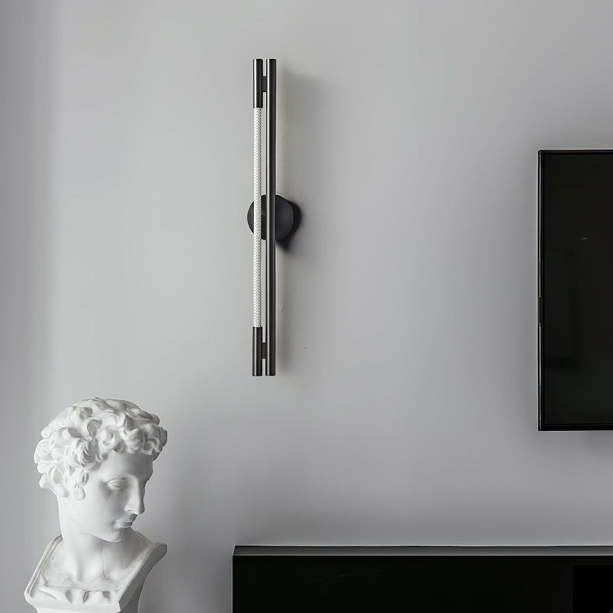 The bar on a gray wall above a low cabinet with a plaster bust