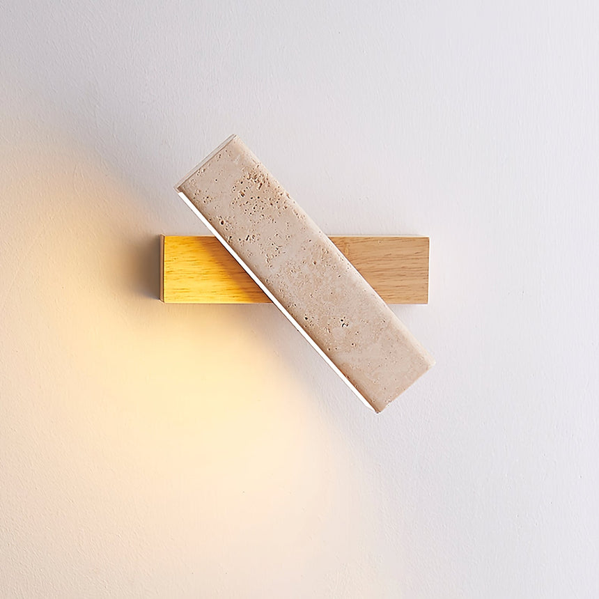 The crossed bars lit on a pale wall, light spilling along the wood