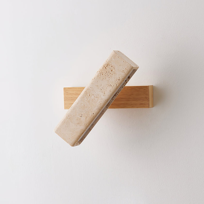 The crossed bars unlit on a pale wall, the stone matte against the wood