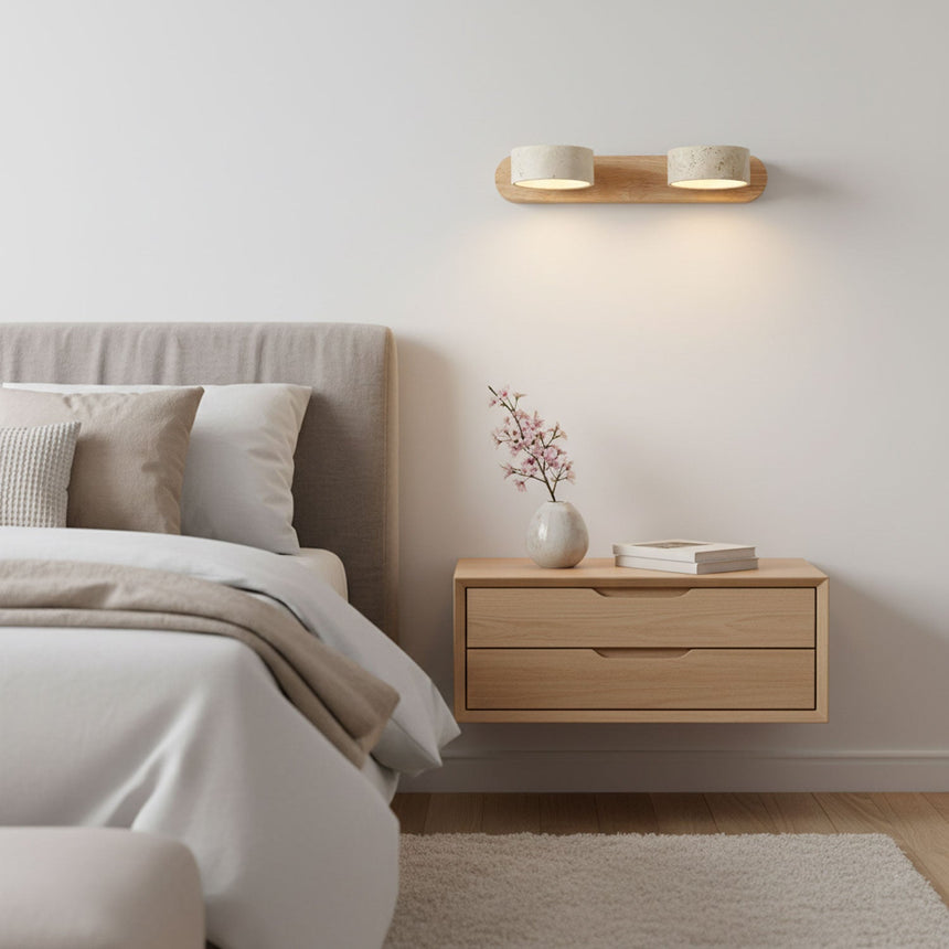 Travertine bar lit above a floating nightstand beside a made bed