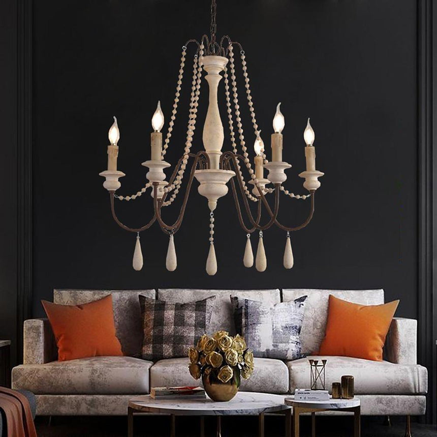 Lit against a dark wall above a sofa with orange and checked cushions