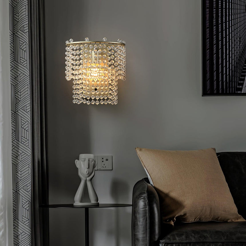 The beaded sconce above a side table and a leather armchair with a cushion
