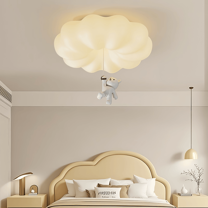 Cloud bear ceiling light above a child bed with a cloud shaped headboard